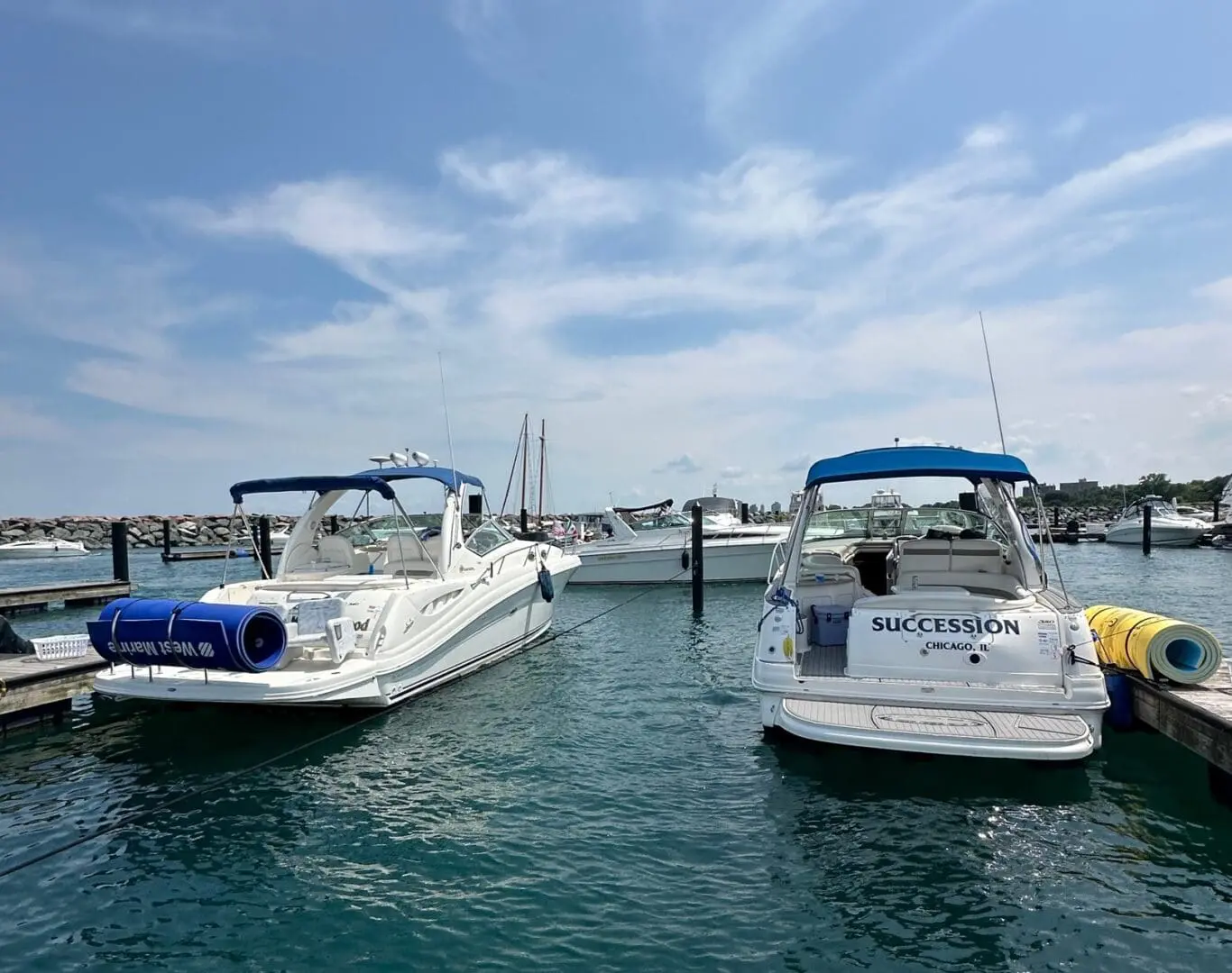 Two boats are docked in the water.